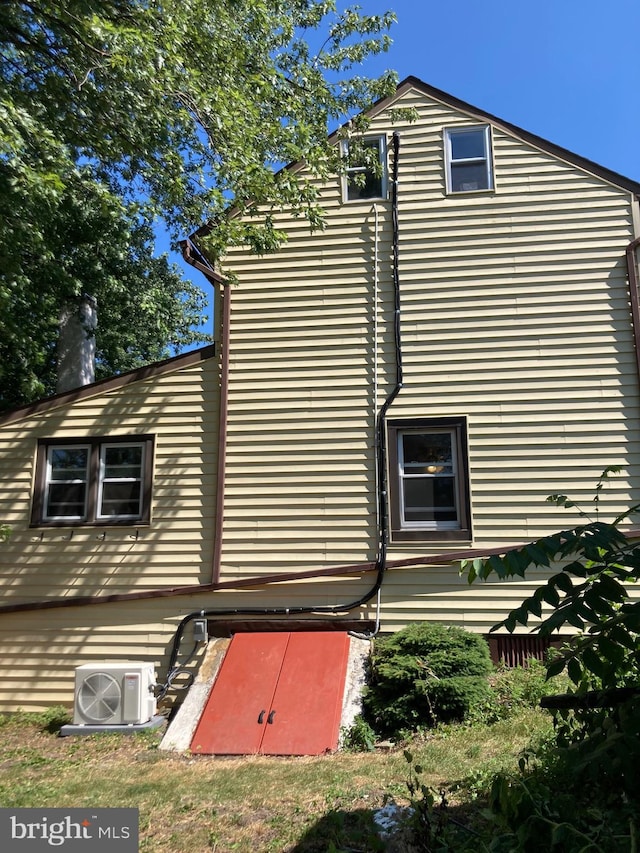 view of side of property with ac unit