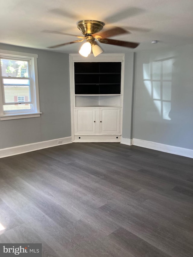 empty room featuring ceiling fan and dark hardwood / wood-style flooring