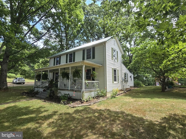 view of front of home with covered porch and a front lawn