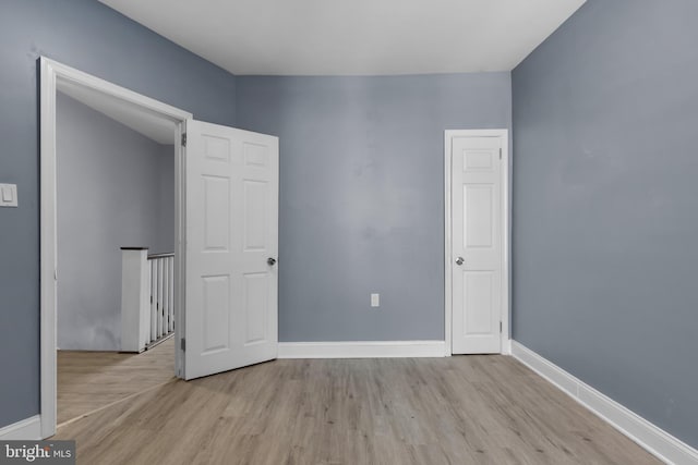 unfurnished bedroom with light wood-type flooring