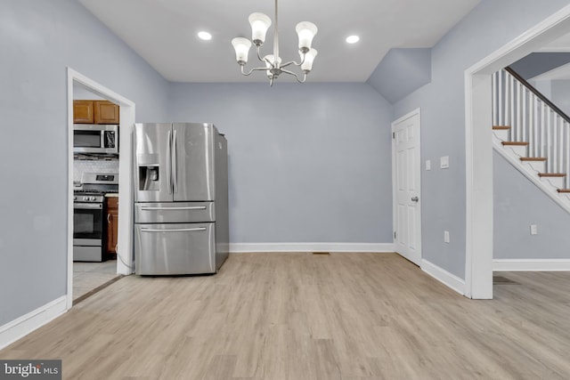 kitchen with hanging light fixtures, tasteful backsplash, light hardwood / wood-style flooring, a notable chandelier, and appliances with stainless steel finishes