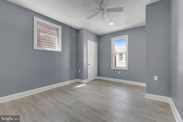 empty room with ceiling fan and light wood-type flooring