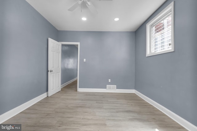 unfurnished room with light wood-type flooring and ceiling fan