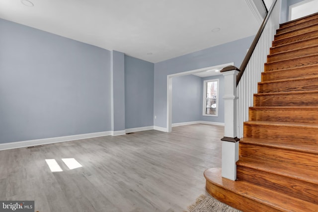 staircase with hardwood / wood-style flooring