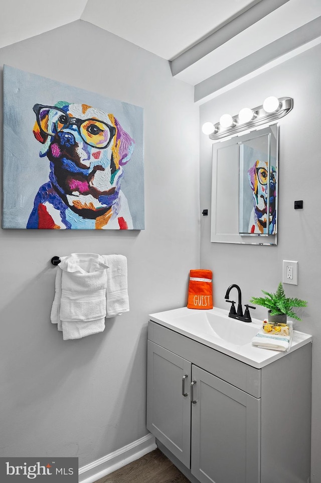 bathroom with vanity and lofted ceiling