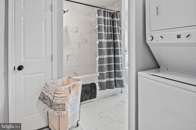 bathroom with shower / tub combo, stacked washer and dryer, and toilet