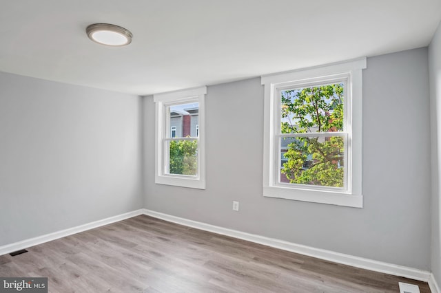 unfurnished room featuring hardwood / wood-style floors