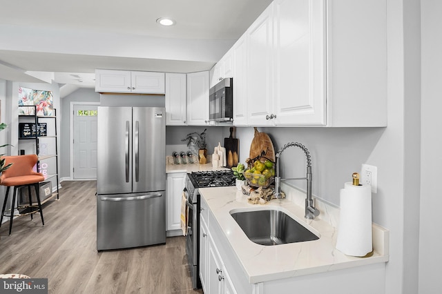 kitchen with white cabinets, stainless steel appliances, and sink