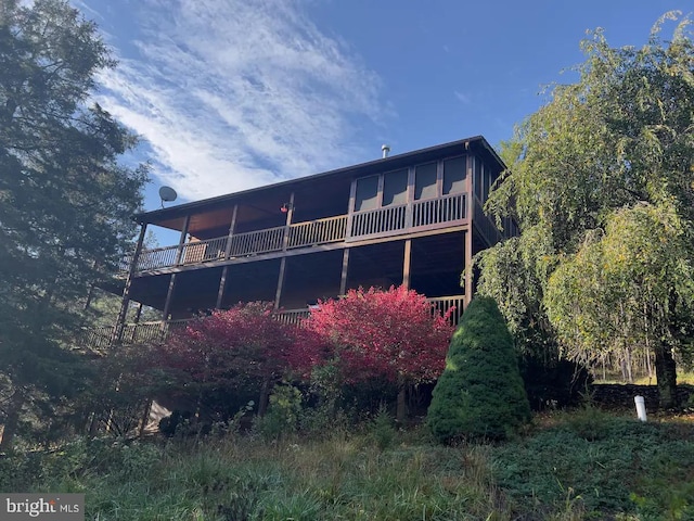 back of property featuring a balcony