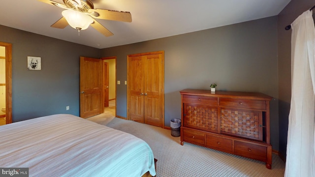 bedroom with ceiling fan and light carpet