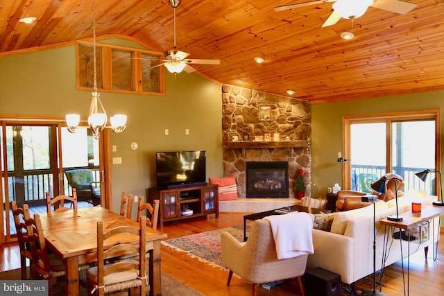 living room with hardwood / wood-style floors, ceiling fan with notable chandelier, vaulted ceiling, a fireplace, and wood ceiling