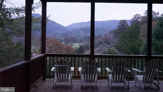 wooden deck with a mountain view