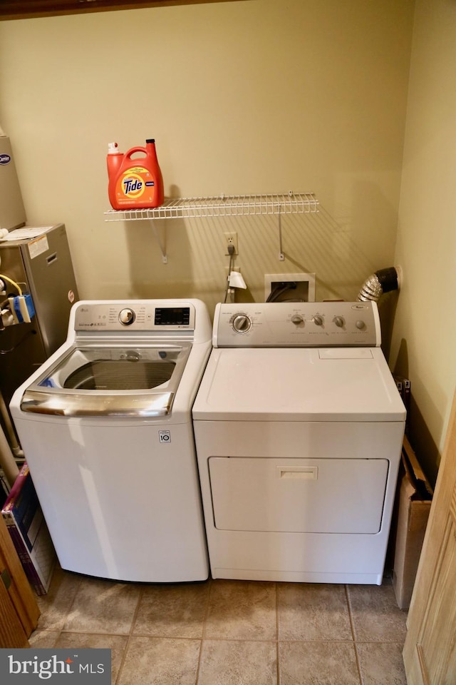 clothes washing area with washing machine and clothes dryer