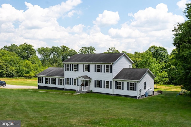 colonial-style house with a front yard