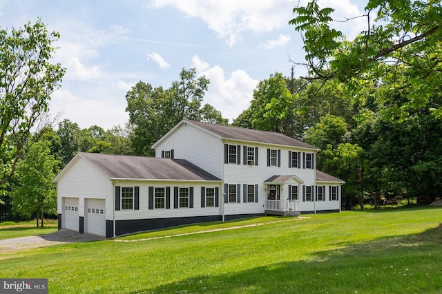 colonial-style house with a front yard and a garage