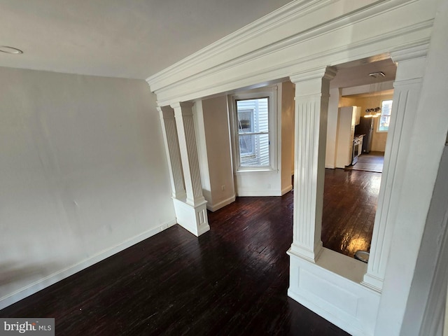 interior space with ornamental molding, ornate columns, and dark wood-type flooring