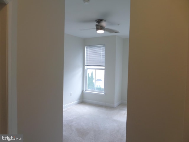 empty room with ceiling fan and light colored carpet