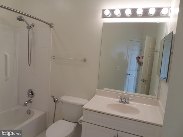 full bathroom featuring tiled shower / bath, vanity, and toilet