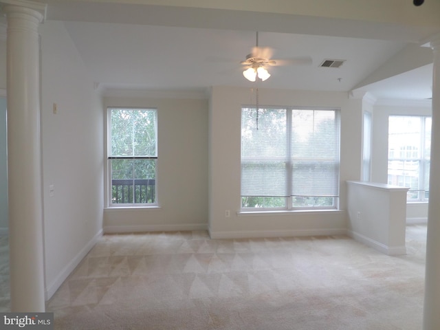 spare room featuring light carpet, lofted ceiling, and plenty of natural light