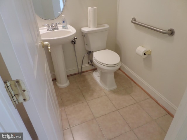 bathroom featuring tile patterned flooring and toilet