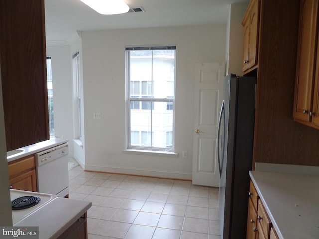 kitchen with stainless steel fridge, ornamental molding, dishwasher, and light tile patterned floors