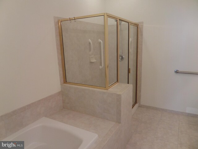 bathroom featuring independent shower and bath and tile patterned flooring