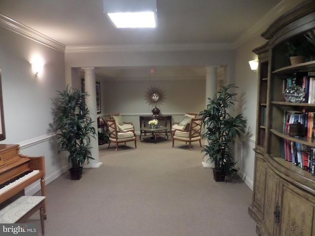 sitting room with light colored carpet, ornamental molding, and decorative columns