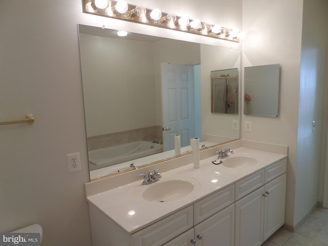 bathroom featuring vanity, a bathing tub, and tile patterned floors