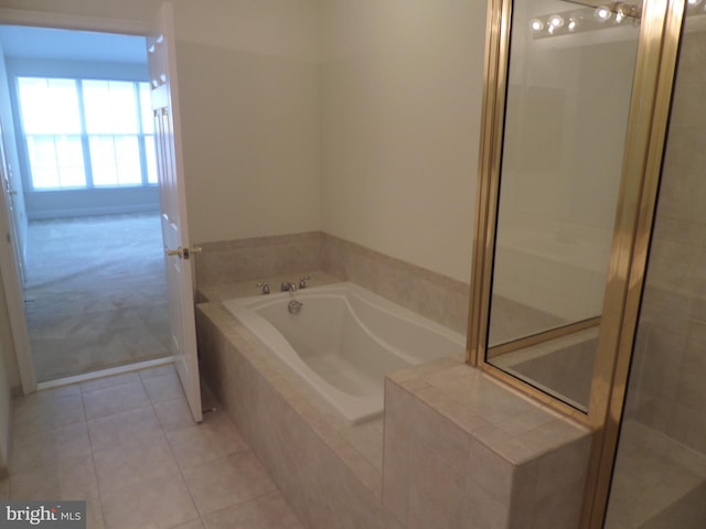 bathroom with separate shower and tub and tile patterned flooring