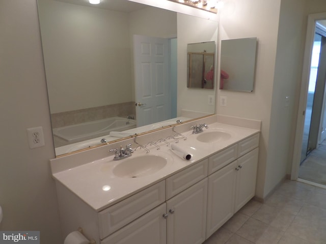 bathroom featuring vanity, a bathtub, and tile patterned floors