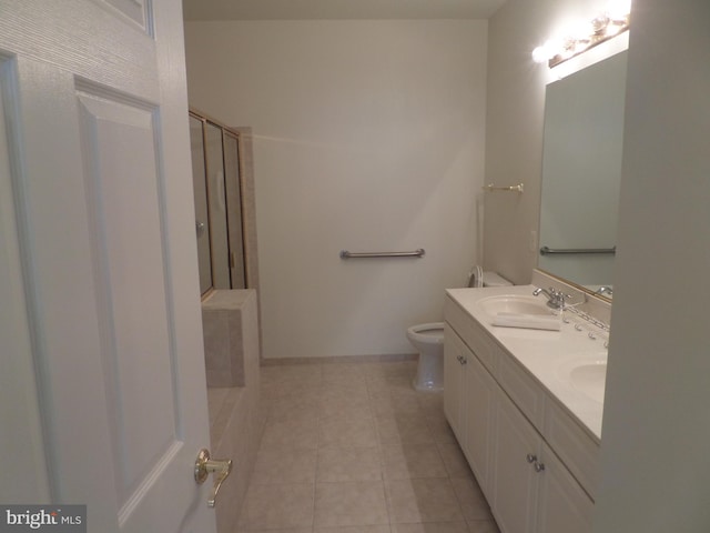 bathroom with walk in shower, vanity, toilet, and tile patterned floors