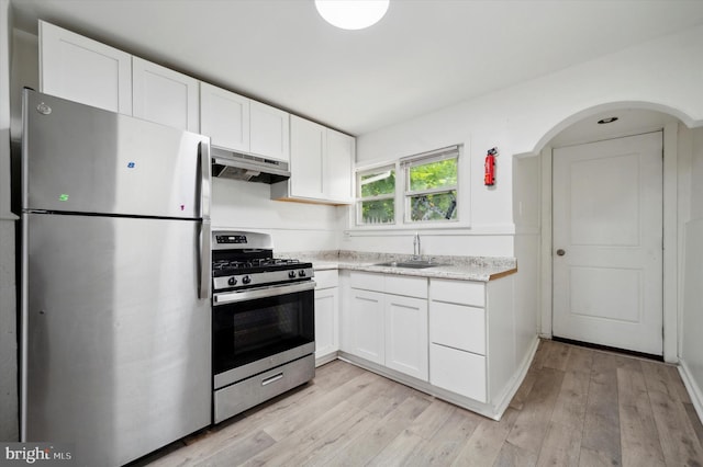 kitchen featuring white cabinetry, appliances with stainless steel finishes, sink, and light wood-type flooring