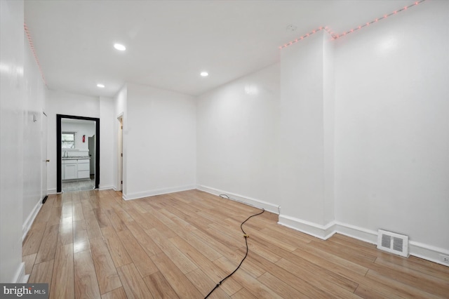 spare room with light hardwood / wood-style flooring