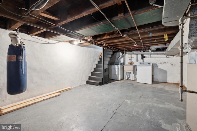 basement with washer and clothes dryer and sink