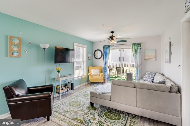 living room featuring hardwood / wood-style flooring, plenty of natural light, and ceiling fan