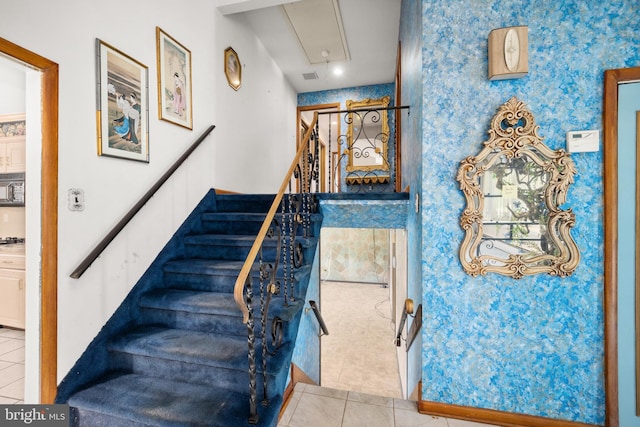 stairway featuring tile patterned flooring