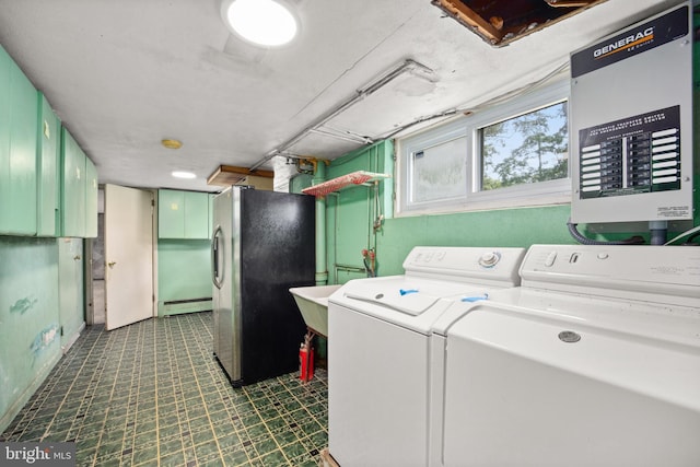 laundry room featuring separate washer and dryer and a baseboard heating unit