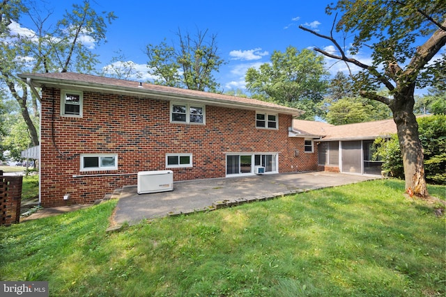 back of property with a patio and a lawn