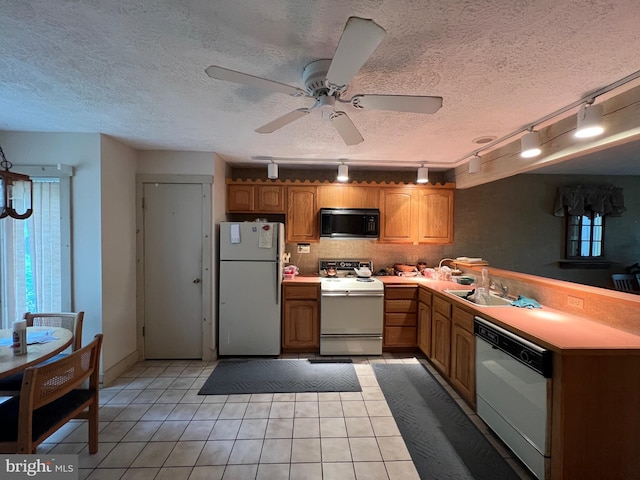 kitchen with ceiling fan, light tile patterned flooring, white appliances, and track lighting