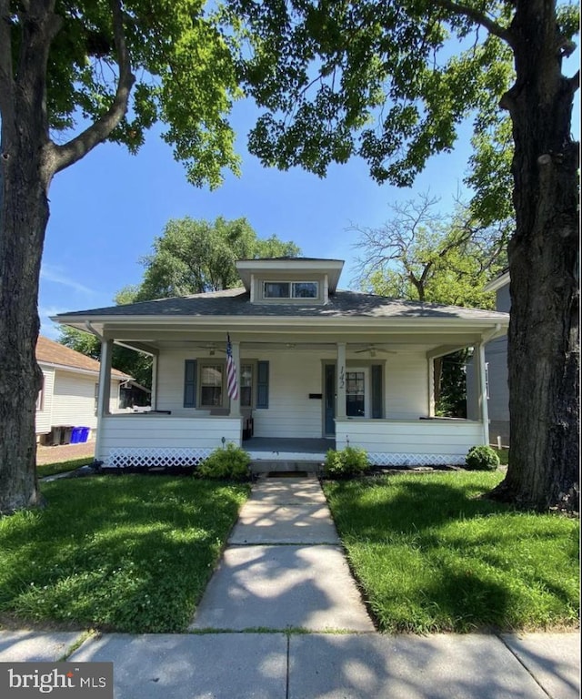 view of front of home with a porch and a front yard