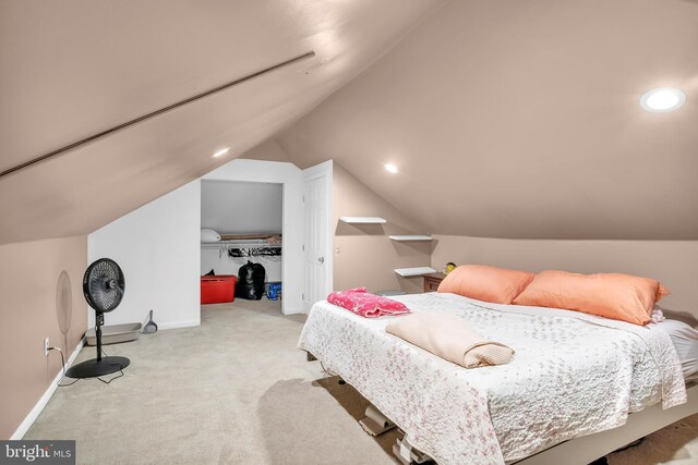 carpeted bedroom featuring lofted ceiling and a closet