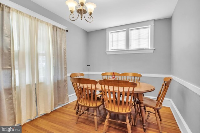 dining room featuring a chandelier and light wood-type flooring