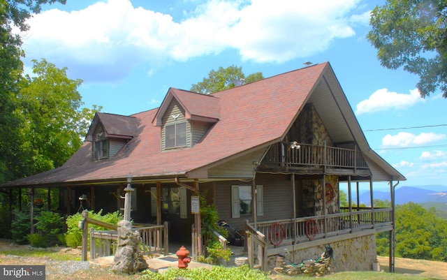 view of front of property featuring covered porch and a balcony