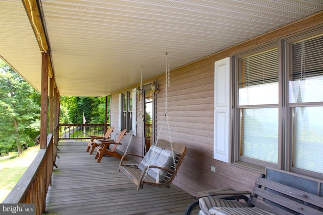 wooden terrace featuring covered porch