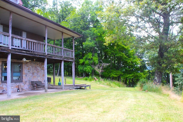 view of yard featuring a patio and a wooden deck