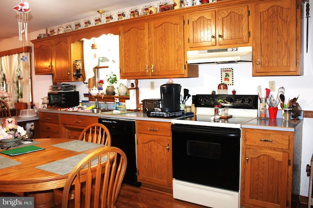 kitchen featuring sink, dark hardwood / wood-style floors, and black appliances