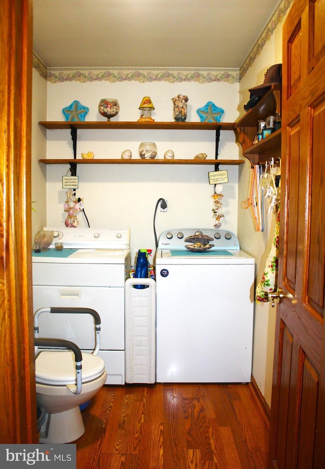 laundry area featuring washing machine and dryer and dark wood-type flooring