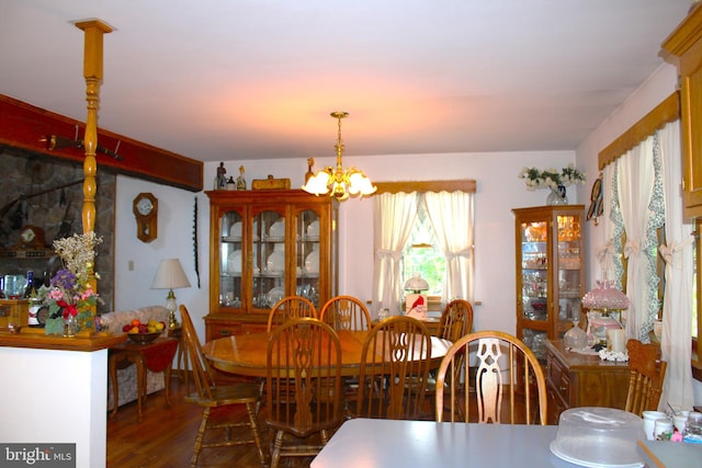 dining room featuring dark hardwood / wood-style flooring and a chandelier