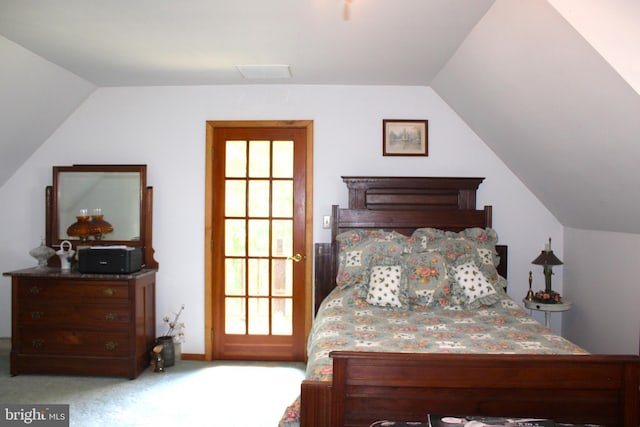 carpeted bedroom with lofted ceiling