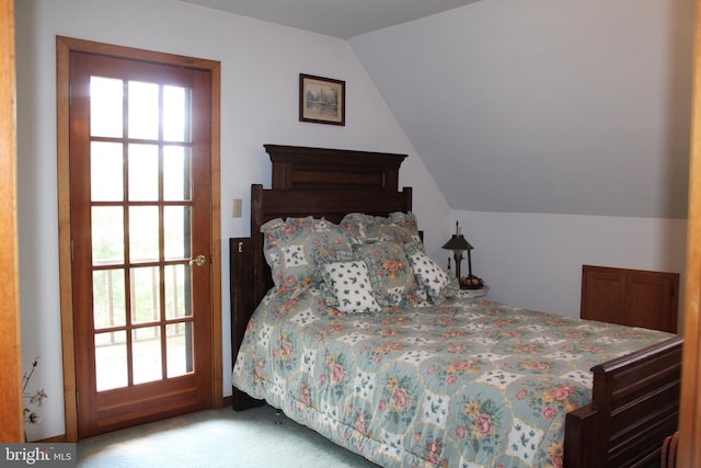 carpeted bedroom featuring lofted ceiling